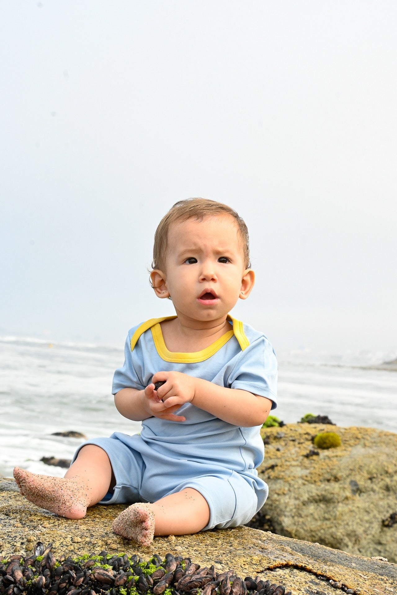 Baby in Blue and Yellow onesie and shorts