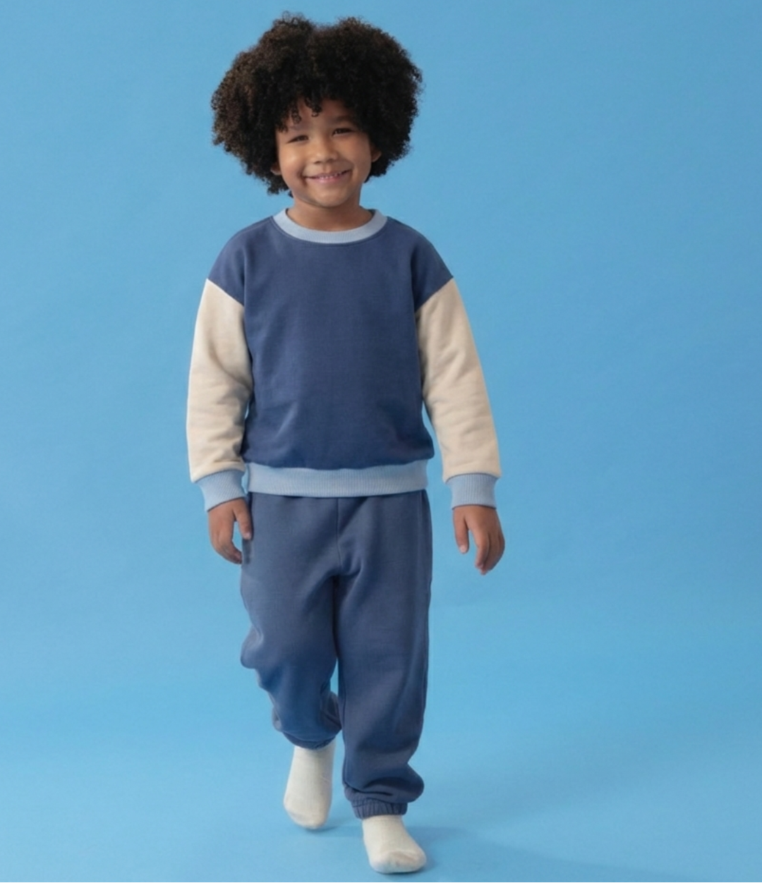 Blue Trio, Navy Blue | Child wearing a blue and beige outfit on a blue background