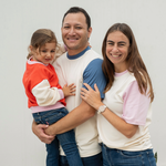 Matching Family in Adult Color Block Navy Blue with White, White with Pink Tshirts and toddler wearing Red Trio Arquia Sweatshirt