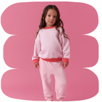 Pink | Young girl wearing a pink outfit on a pink background