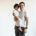 White | Man holding a child in matching outfits