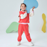 Engine Red | Child wearing a red outfit holding a blue speech bubble-shaped object against a white background