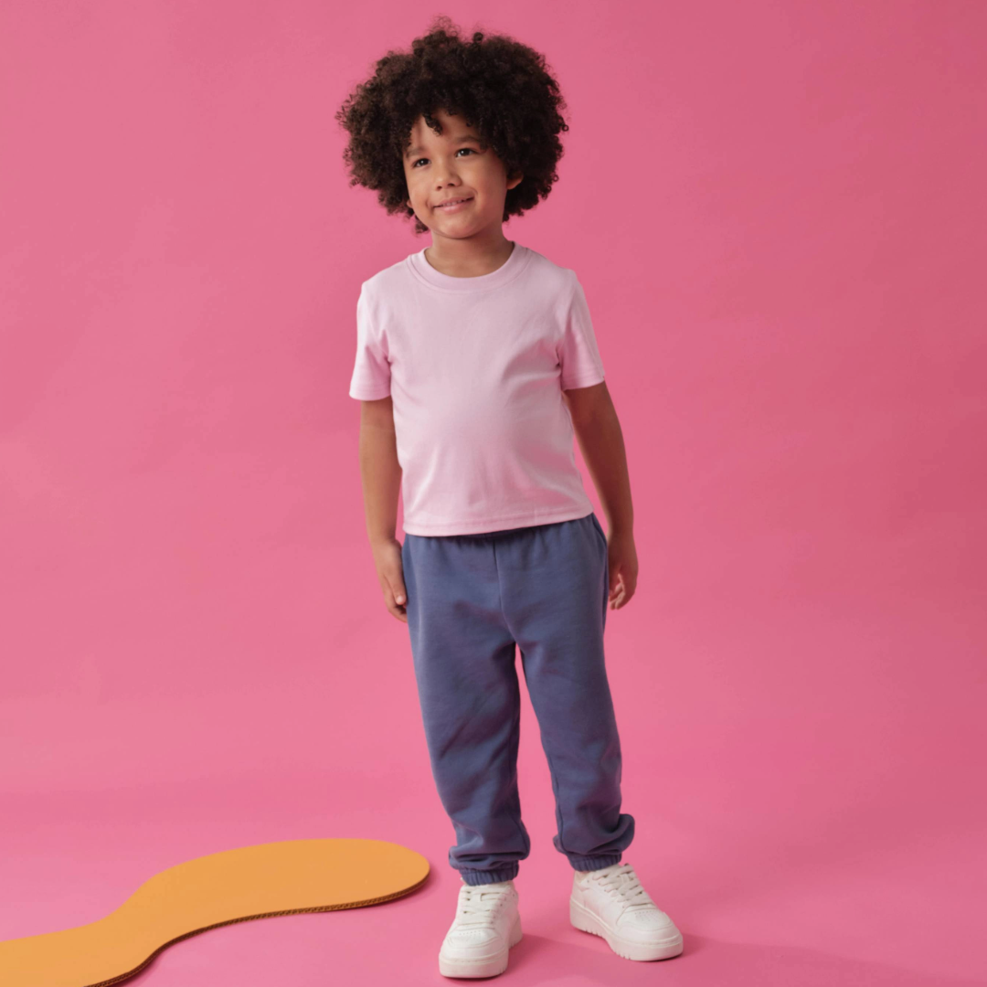 toddler wearing Arquia kids solid pink tshirt and navy blue sweatpants