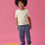 Toddler wearing Arquia solid tshirt in white and navy blue sweatpants