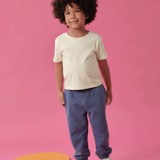 Toddler wearing Arquia solid tshirt in white and navy blue sweatpants