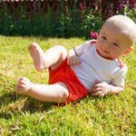 Baby playing in Sunny Day Set: short sleeve bodysuit and shorts in red made in 100% peruvian pima cotton