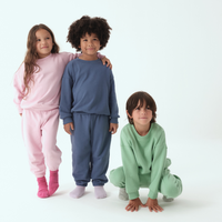 Grass Green; Pink; Navy Blue | Three children wearing colorful sweats on a white background