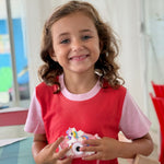 Engine Red with Pink | Young girl holding a toy camera